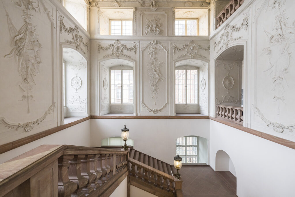 Atop of the stairs leading up to the first floor rooms are on either side
